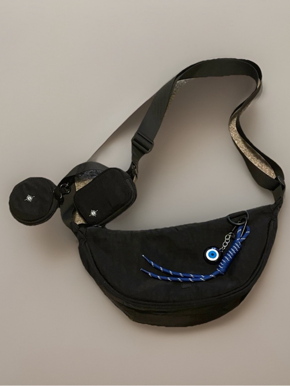 Black Crossbody Sling Bag with Blue Eyewear Charm